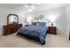 Comfortable primary bedroom with traditional furniture including matching nightstands and dresser with mirror at 17461 Se 82Nd Albemarle Ave, The Villages, FL 32162