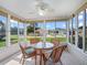 Inviting sunroom with wicker furniture and a glass table, surrounded by windows offering bright views at 17461 Se 82Nd Albemarle Ave, The Villages, FL 32162