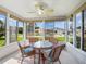 Inviting sunroom with wicker furniture and a glass table, surrounded by windows offering bright views at 17461 Se 82Nd Albemarle Ave, The Villages, FL 32162