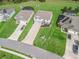 Aerial view of suburban homes with manicured lawns and driveways, featuring mature landscaping and neighborhood charm at 1824 Forest Glen Dr, Fruitland Park, FL 34731