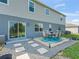 Backyard with a patio dining area and stone pathway, perfect for outdoor relaxation and entertaining at 1824 Forest Glen Dr, Fruitland Park, FL 34731