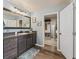 Bathroom featuring a single sink vanity, framed mirror, and access to a walk-in closet at 1824 Forest Glen Dr, Fruitland Park, FL 34731