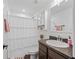 Bright bathroom featuring a shower, white curtain, vanity, toilet, cabinet and neutral tones throughout at 1824 Forest Glen Dr, Fruitland Park, FL 34731