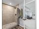 Modern bathroom featuring a walk-in shower with sleek fixtures and a view into an adjacent living area at 1824 Forest Glen Dr, Fruitland Park, FL 34731