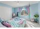Light blue bedroom with a window, plush carpet and an adorable character themed bed at 1824 Forest Glen Dr, Fruitland Park, FL 34731