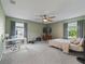 Bedroom with carpet flooring, windows, and a ceiling fan at 1824 Forest Glen Dr, Fruitland Park, FL 34731