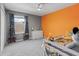 ' bedroom with neutral gray walls and an orange accent wall and an excavator themed decor at 1824 Forest Glen Dr, Fruitland Park, FL 34731