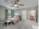 Bedroom with green walls, carpet flooring, a ceiling fan, and a walk-in closet at 1824 Forest Glen Dr, Fruitland Park, FL 34731
