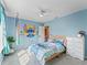 Bright bedroom with light blue walls, grey carpet, a ceiling fan and cute wall decor at 1824 Forest Glen Dr, Fruitland Park, FL 34731