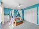 Light blue bedroom with a canopy bed, window and white closet doors at 1824 Forest Glen Dr, Fruitland Park, FL 34731