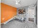 ' bedroom with an orange accent wall and an excavator themed decor at 1824 Forest Glen Dr, Fruitland Park, FL 34731