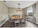 Cozy dining room with wood floors, table, and ample natural light from a large window at 1824 Forest Glen Dr, Fruitland Park, FL 34731