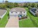 Beautiful two-story home with well-manicured lawn and a three car garage and a bright blue front door at 1824 Forest Glen Dr, Fruitland Park, FL 34731