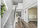 Bright foyer featuring hardwood floors, staircase, and an open view into the living spaces at 1824 Forest Glen Dr, Fruitland Park, FL 34731