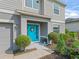 Close up view of a bright blue front door with modern hardware and a decorative wreath at 1824 Forest Glen Dr, Fruitland Park, FL 34731
