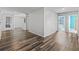 Hallway with multiple doorways and wood-look flooring, showcasing spaciousness and connectivity at 1824 Forest Glen Dr, Fruitland Park, FL 34731