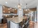 Kitchen with dark wood cabinets, granite countertops, stainless steel appliances, and a kitchen island with barstool seating at 1824 Forest Glen Dr, Fruitland Park, FL 34731