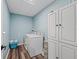 Convenient laundry room with a washer, dryer, and built-in storage, perfect for organization and efficiency at 1824 Forest Glen Dr, Fruitland Park, FL 34731