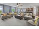 Open concept living room with plenty of seating, and natural light, flowing into the dining area at 1824 Forest Glen Dr, Fruitland Park, FL 34731