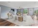 Spacious living room with comfortable seating, fireplace, and open layout to dining area at 1824 Forest Glen Dr, Fruitland Park, FL 34731