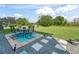 Outdoor patio with seating area, pavers, gravel and open green space for outdoor enjoyment at 1824 Forest Glen Dr, Fruitland Park, FL 34731