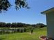 Lush backyard view of pond and trees at 20936 Royal St Georges Ln, Leesburg, FL 34748