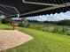 Large patio with awning looking onto the backyard view of the water at 20936 Royal St Georges Ln, Leesburg, FL 34748