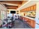 Bar area in clubhouse features seating, a counter, liquor storage, and television viewing at 20936 Royal St Georges Ln, Leesburg, FL 34748