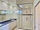 Bright bathroom with glass enclosed shower with many shower heads and white vanity at 20936 Royal St Georges Ln, Leesburg, FL 34748
