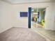 Bright bedroom boasts tile and carpet flooring, sliding glass door, and access to outdoor area at 20936 Royal St Georges Ln, Leesburg, FL 34748