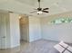 Bright bedroom features neutral carpet, fan and unique transom window offering lots of natural light at 20936 Royal St Georges Ln, Leesburg, FL 34748