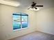 Cozy bedroom with a large window providing ample natural light at 20936 Royal St Georges Ln, Leesburg, FL 34748