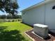Exterior view of the house with a generator and a view of the pond at 20936 Royal St Georges Ln, Leesburg, FL 34748