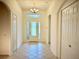 Spacious foyer featuring tile flooring, chandelier, and glass front door at 20936 Royal St Georges Ln, Leesburg, FL 34748