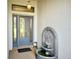 Arched entryway with leaded glass door and an antique tiered fountain at 20936 Royal St Georges Ln, Leesburg, FL 34748