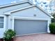 Garage featuring an automatic roll down bug screen at 20936 Royal St Georges Ln, Leesburg, FL 34748