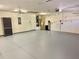 Large, light grey garage featuring ceiling fans, a utility sink, and water heater at 20936 Royal St Georges Ln, Leesburg, FL 34748