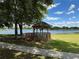 Lakeside gazebo near a tree with sidewalk and grassy area in Royal Highlands at 20936 Royal St Georges Ln, Leesburg, FL 34748