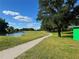 Picturesque golf course featuring lush green fairways, mature trees, and a winding path at 20936 Royal St Georges Ln, Leesburg, FL 34748