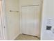 Hallway featuring tile flooring, bi-fold doors to closet space, neutral walls and modern fixtures at 20936 Royal St Georges Ln, Leesburg, FL 34748