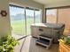 Enclosed sunroom with a hot tub overlooking the lush green golf course for relaxation and enjoyment at 20936 Royal St Georges Ln, Leesburg, FL 34748