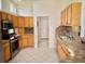 Well-lit kitchen with stainless appliances, light wood cabinetry, and ample counter space at 20936 Royal St Georges Ln, Leesburg, FL 34748