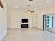 Open-concept living room with sliding glass doors to the lanai, ceiling fan, and tile flooring at 20936 Royal St Georges Ln, Leesburg, FL 34748