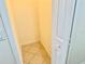 Small storage room with a tiled floor and a convenient light switch at 20936 Royal St Georges Ln, Leesburg, FL 34748