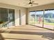 Bright sunroom features tile flooring and expansive windows, with views of the backyard and fountain at 20936 Royal St Georges Ln, Leesburg, FL 34748