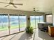 Bright sunroom has multi-pane glass doors with views of the backyard and a jacuzzi tub at 20936 Royal St Georges Ln, Leesburg, FL 34748