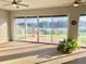 Bright sunroom with views of the back yard and fountain and multi-pane glass doors at 20936 Royal St Georges Ln, Leesburg, FL 34748