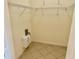Walk-in closet with shelving and tile floor with neutral walls and lighting at 20936 Royal St Georges Ln, Leesburg, FL 34748