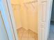 Walk-in closet features shelving and tile floor with neutral walls and doorway at 20936 Royal St Georges Ln, Leesburg, FL 34748