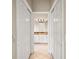 En suite bathroom with sliding doors features double sinks, granite countertops, and tiled floors at 2104 Gerardo Ave, The Villages, FL 32159
